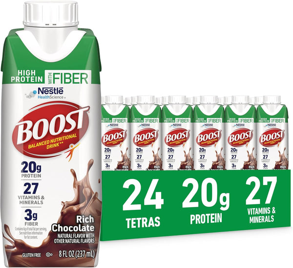 A single bottle of Nestle Boost High Protein and Fiber chocolate drink powder stands next to a green cardboard multipack display holding 24 small tetra packs. The packaging prominently features the Nestle logo, the word 'Boost' in red, and flavor text for Rich Chocolate.