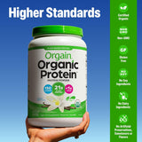 Orgain Organic Protein powder container held by a hand with certification icons on a blue background